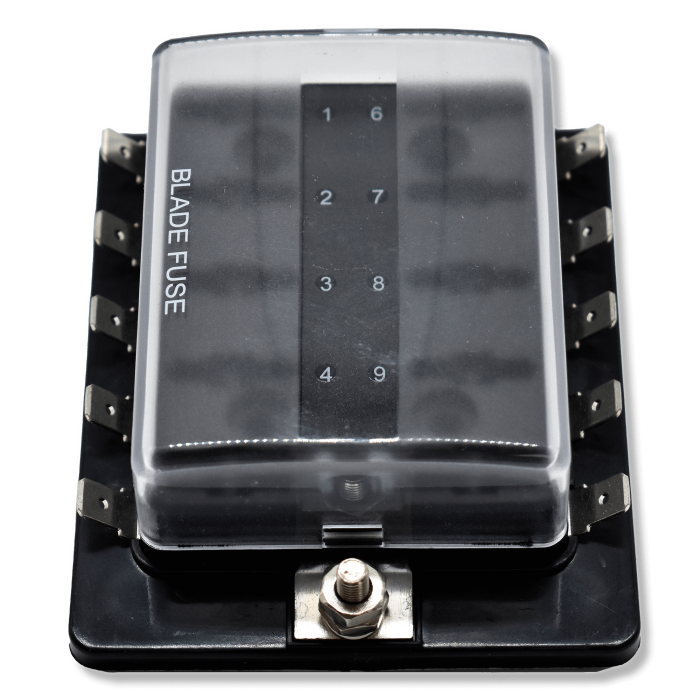 Top view of fuse block with clear hinged cover, numbered slots, mounting stud and side blade terminals