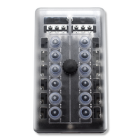 Front view of breaker block with translucent cover revealing 12 rubber boots, central knob and top terminals.