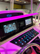 Grady‑White Bimini 306 dash close-up showing dual Garmin screens, stereo and illuminated labeled switch panel