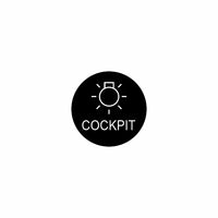 Front view of round black badge showing a light pictogram and the word 'COCKPIT'.
