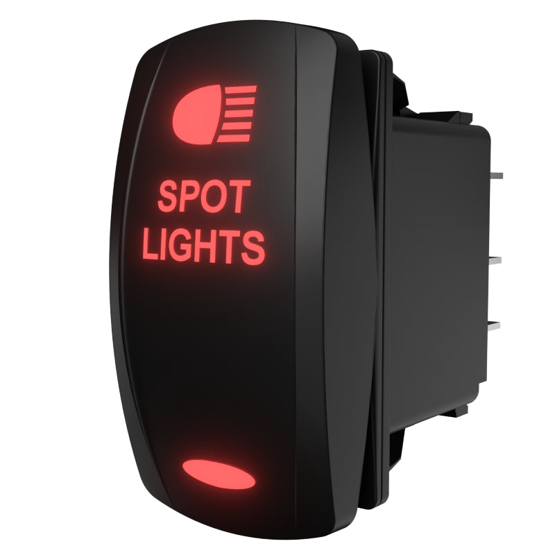 Angled side/rear view of illuminated rocker switch labeled SPOT LIGHTS showing rear pins and mounting clip