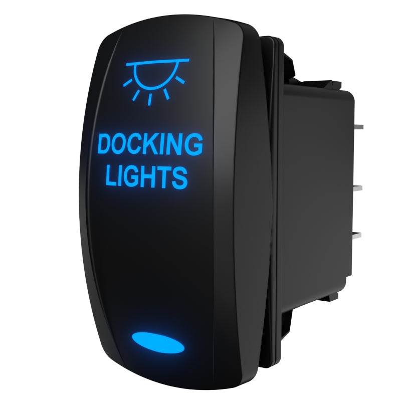 Angled side view of Docking Lights rocker switch showing illuminated blue legend and rear spade terminals.