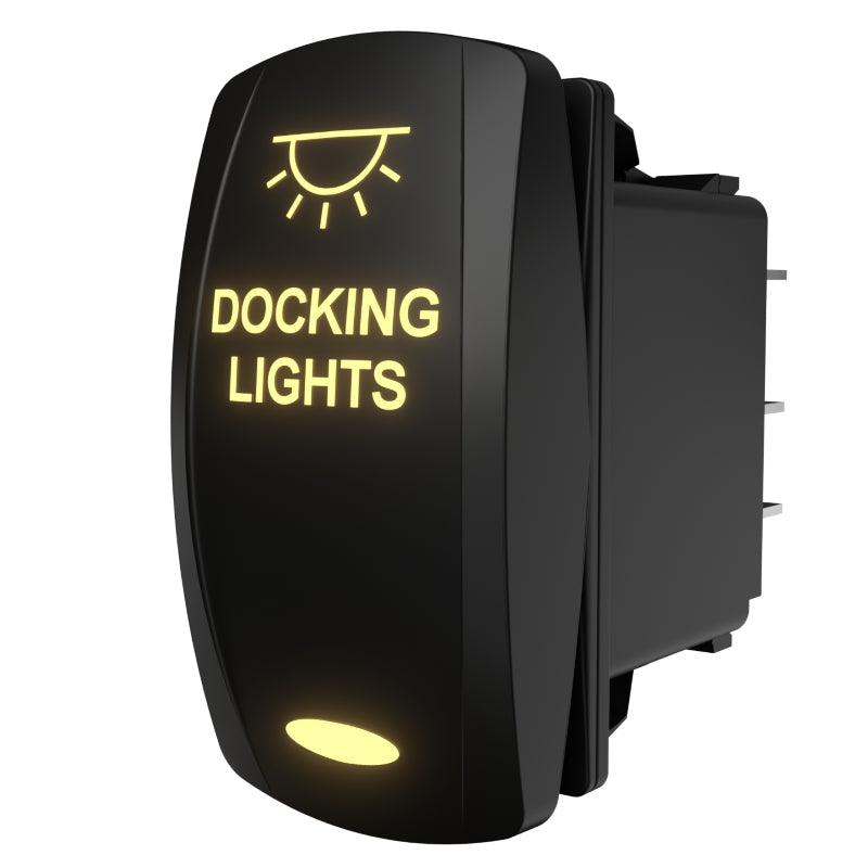 Angled front-right view of illuminated black rocker switch labeled DOCKING LIGHTS showing rear spade terminals