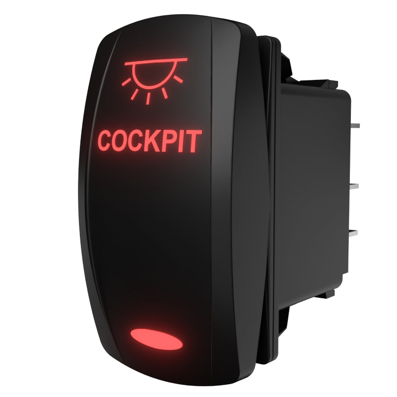 Rear-right view of Carling cockpit rocker switch with glowing "COCKPIT" legend and exposed rear terminals