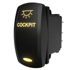 Side-angle view of illuminated cockpit rocker switch showing lit "COCKPIT" legend and rear spade terminals.