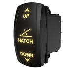 Angled rear view of Carling hatch rocker switch with lit UP/HATCH/DOWN legends and connector pins.