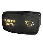 Front-right angled view of illuminated rocker switch showing TRANSOM LIGHTS text, sun icon and rear connector