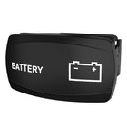 Angled front view of black rocker switch marked BATTERY with battery icon and visible rear mounting clip