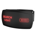 Angled front view of black backlit rocker switch labeled "SEARCH LIGHT" in red with LED icon and rear connector visible