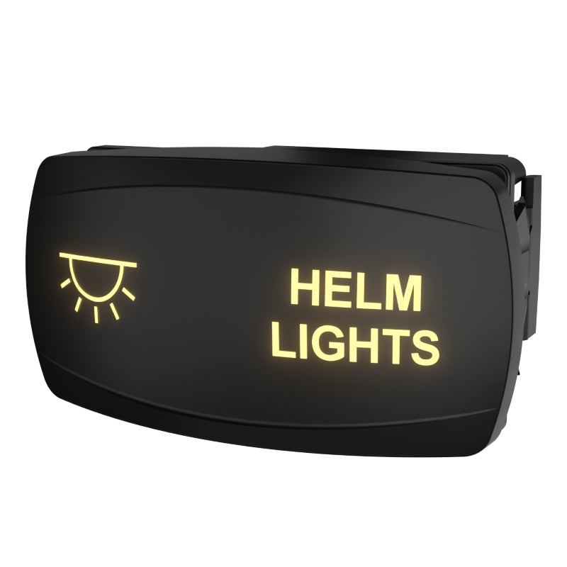 Angled rear-side view of Helm Lights rocker switch showing illuminated legend and mounting clip/connector.