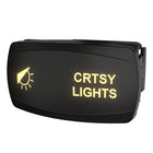 Carling illuminated black rocker switch labeled "CRTSY LIGHTS", angled front-right view showing rear connector and bezel