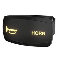 Angled front view of illuminated horn rocker switch showing horn icon, "HORN" text and side mounting clip.