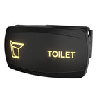 Angled view of illuminated toilet indicator switch panel with yellow toilet icon, 'TOILET' text and rear mounting clip.