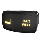 Angled front view of illuminated BAIT WELL rocker switch showing backlit label, icon and mounting clip