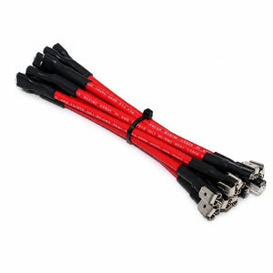 A bundle of red and black high-voltage power cables with metal connector ends, secured with a black zip tie on a white background.