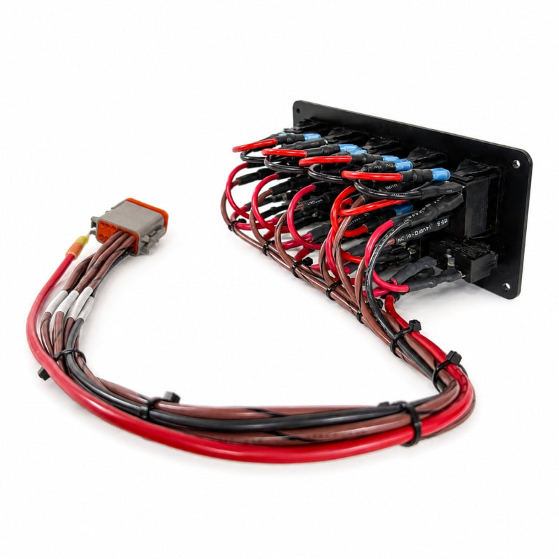 An automotive electrical relay module with a black metal housing, featuring multiple red, black, and brown wires with blue terminal connectors and a multi-pin connector on the left, shown on a white background.