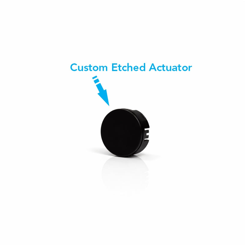 22mm actuator, front-side angle showing blank face and side mounting slots, arrow notes custom etch