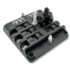 Angled top-side view of the breaker block showing terminal studs, circuit breaker module and mounting holes.