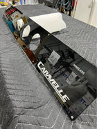Angled view of Caravelle switch panel showing glossy black face, gauge cutouts, 'WINDLASS' label and logo