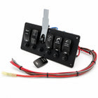 A 4-spoke black control panel with four toggle switches and a separate black remote, accompanied by a bundle of red, gray, and black wiring harnesses on a white background.