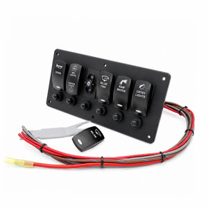 A black 6-light vehicle power panel with toggle switches for horn, wipers, blue/white lights, fan water, and crsby lights, shown with attached wiring harnesses and a small remote on a white background.