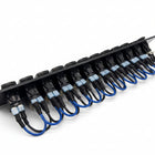 A black multi-button electrical switch panel with multiple blue and black cable ties and blue wires, photographed on a light gray background.