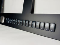 Side-angle close-up of Cobia 277 dash panel showing labeled rocker switches and gauge cutouts