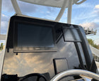 Low-angle view of Contender 31 Tournament helm dash showing dual Garmin displays and T-top supports