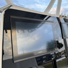 Contender 31 dash panel, angled close-up showing Garmin screen bezel, top mounting flange and T-top supports.
