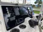 Right-angled view of Robalo R222 dash showing Garmin screen, Yamaha gauges, labeled toggles and cupholders.