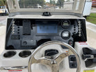 Robalo R222 dash panel front view showing Garmin display, dual Yamaha gauges, toggle switch rows and compass.