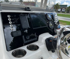 Robalo R222 dash angled view showing Garmin screen, Yamaha gauges, multiple toggle switches and compass