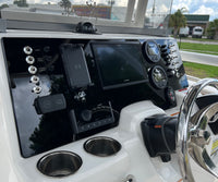 Robalo R222 dash angled view showing Garmin screen, Yamaha gauges, multiple toggle switches and compass