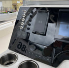 Robalo R222 dash panel angled view showing labeled stainless toggle switches, 12V/USB cover and phone mount