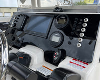 Robalo R222 dash panel angled view showing Garmin display, Yamaha gauges, toggle switches.