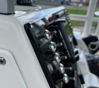Angled close-up of Robalo R222 dash panel showing stainless toggle knobs, chrome bezels and mounting edge