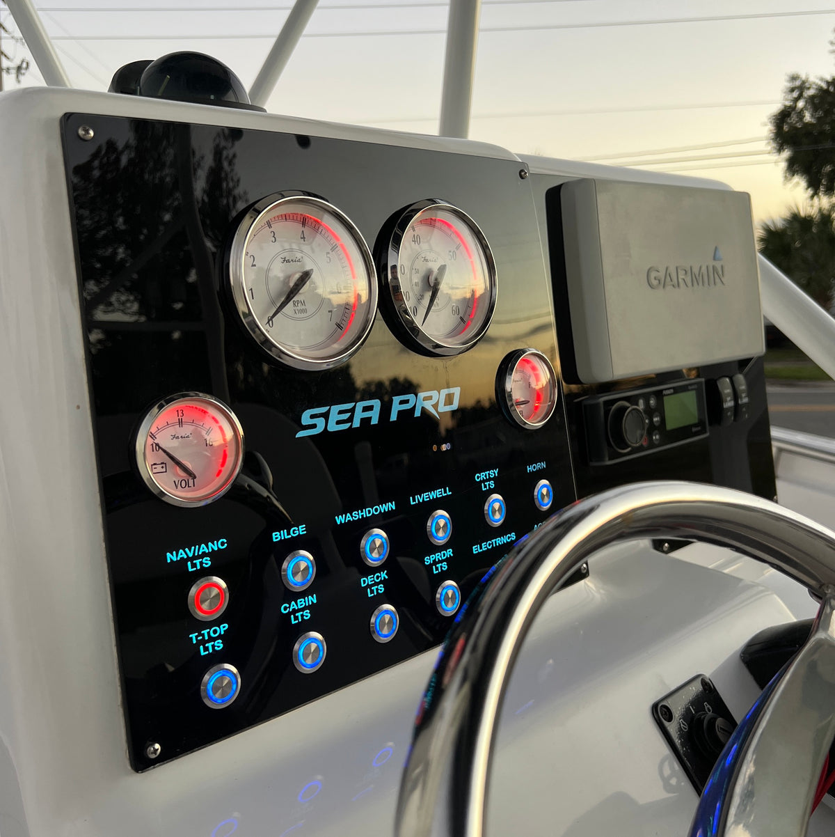 SeaPro 220 CC dash panel front-left angle showing Faria gauges, Garmin unit and illuminated switch labels.