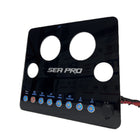 Angled right-side SeaPro dash panel showing circular gauge holes, backlit switches, wiring and power outlet.