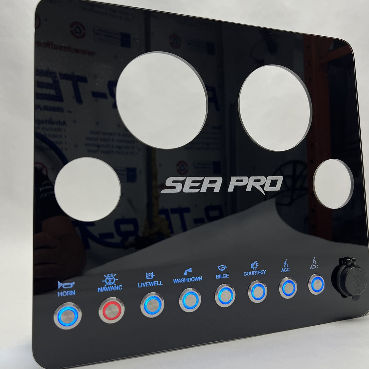 SeaPro 220 CC dash panel front close-up showing circular gauge cutouts, SEA PRO logo and illuminated buttons