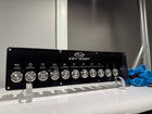 Front view of Key West switch panel showing labeled control icons, metal round switches and blue connectors.