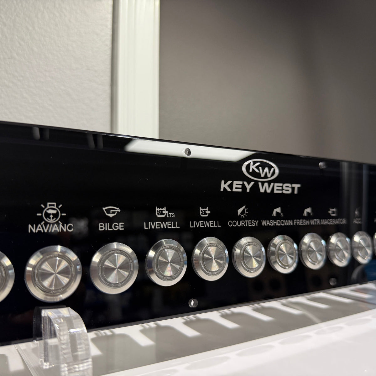 Key West fully loaded marine switch panel labeled NAV/ANC, BILGE and LIVEWELL with round metal knobs