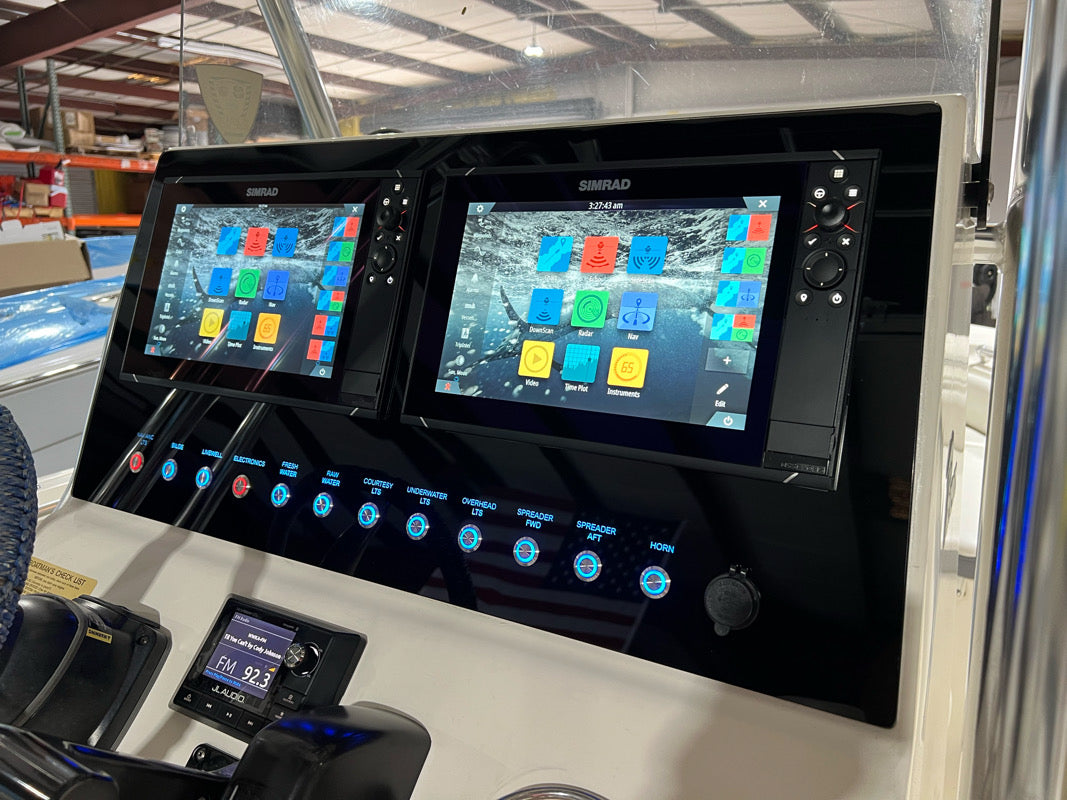 Front-angle view of Key West dash panel installed, showing dual Simrad displays and illuminated switches.