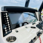 Robalo R302 dash close-up showing dual Garmin screens, left/right switch panels and cup holder.