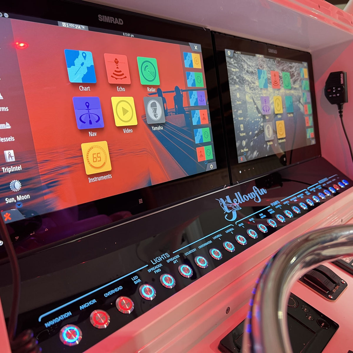 Angled front view of Yellowfin 36 switch panel showing illuminated labeled buttons, logo and dual displays