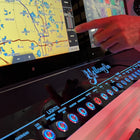Angled front view of Yellowfin 36 switch panel with illuminated ringed buttons, 'LIGHTS' labels and part of a touchscreen