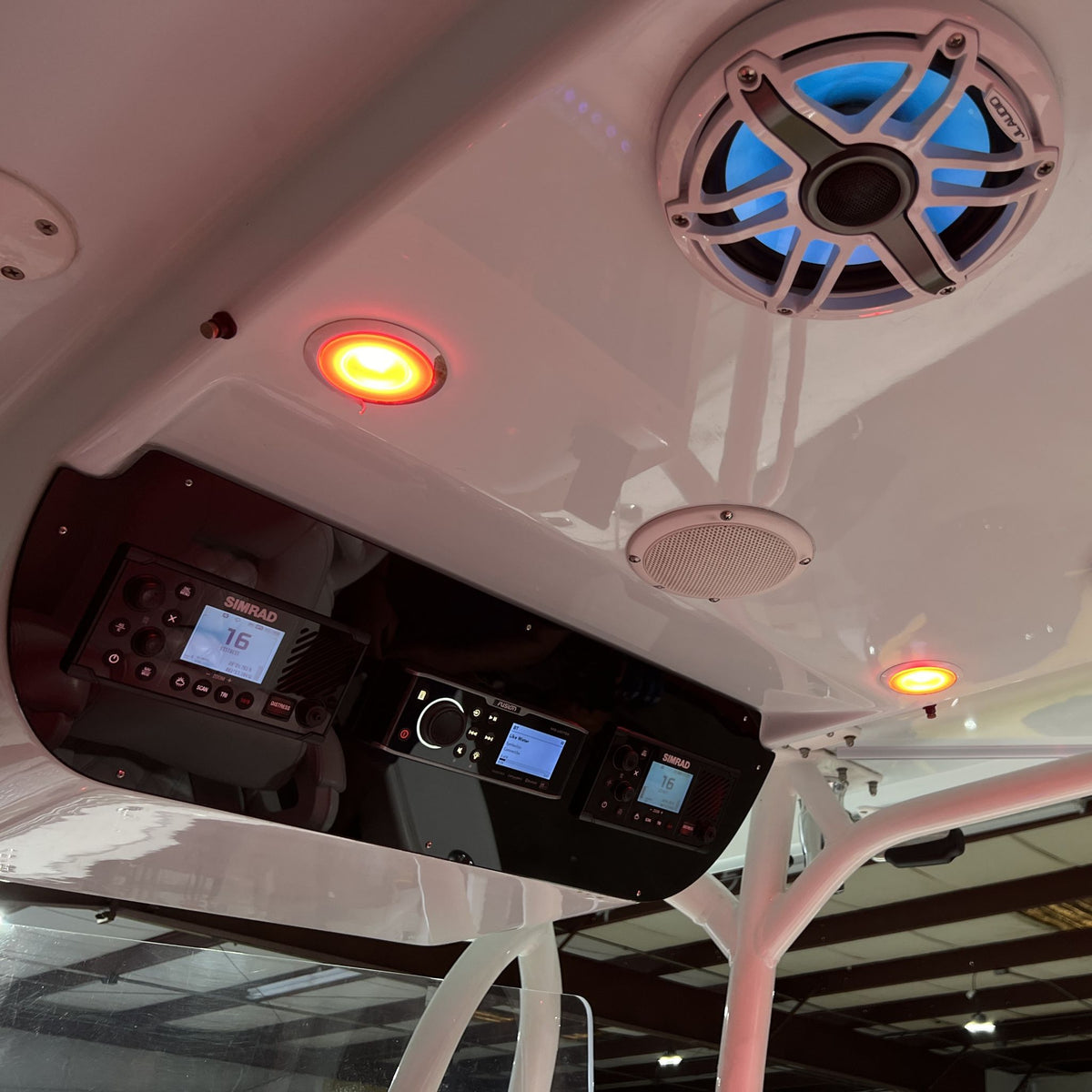 Underside view showing Yellowfin 36 helm switch panel, VHF and stereo displays, speaker and recessed lights