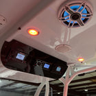 Underside view showing Yellowfin 36 helm switch panel, VHF and stereo displays, speaker and recessed lights